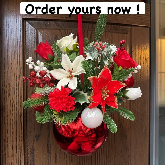 Red and white floral Christmas bauble hanging from a ribbon