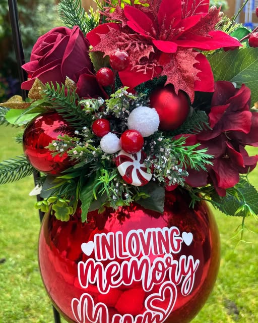 Jane’s red memorial bauble filled with artificial roses, festive flowers and greenery